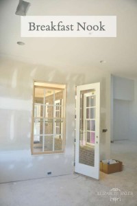 unfinished drywall in breakfast nook leading to back porch