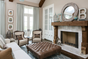 grey living room with turquoise curtains and wood mantel